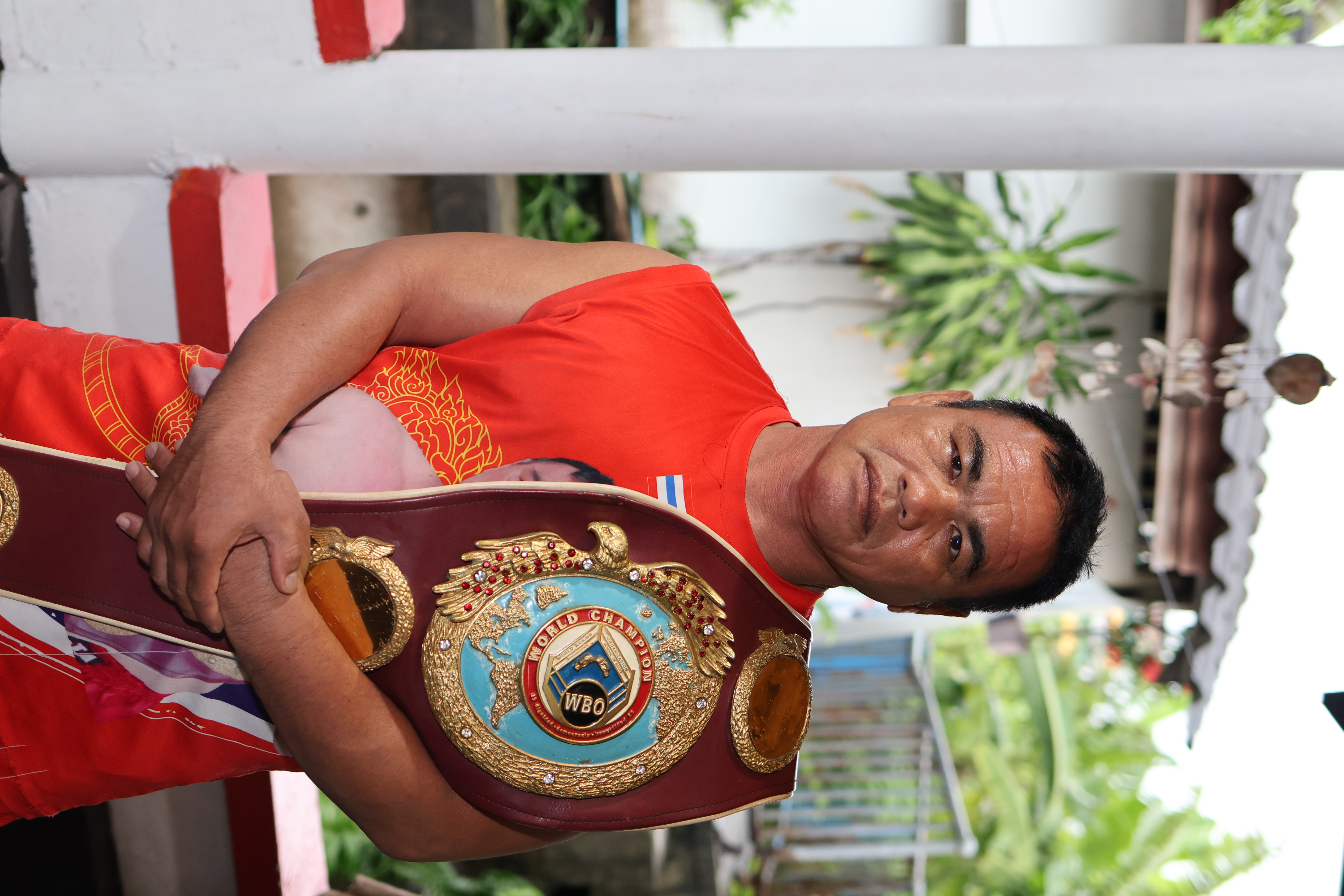 Ratanachai Sor Vorapin (Kru Lek) holding WBO Bantamweight Championship belt, former world champion and technical director